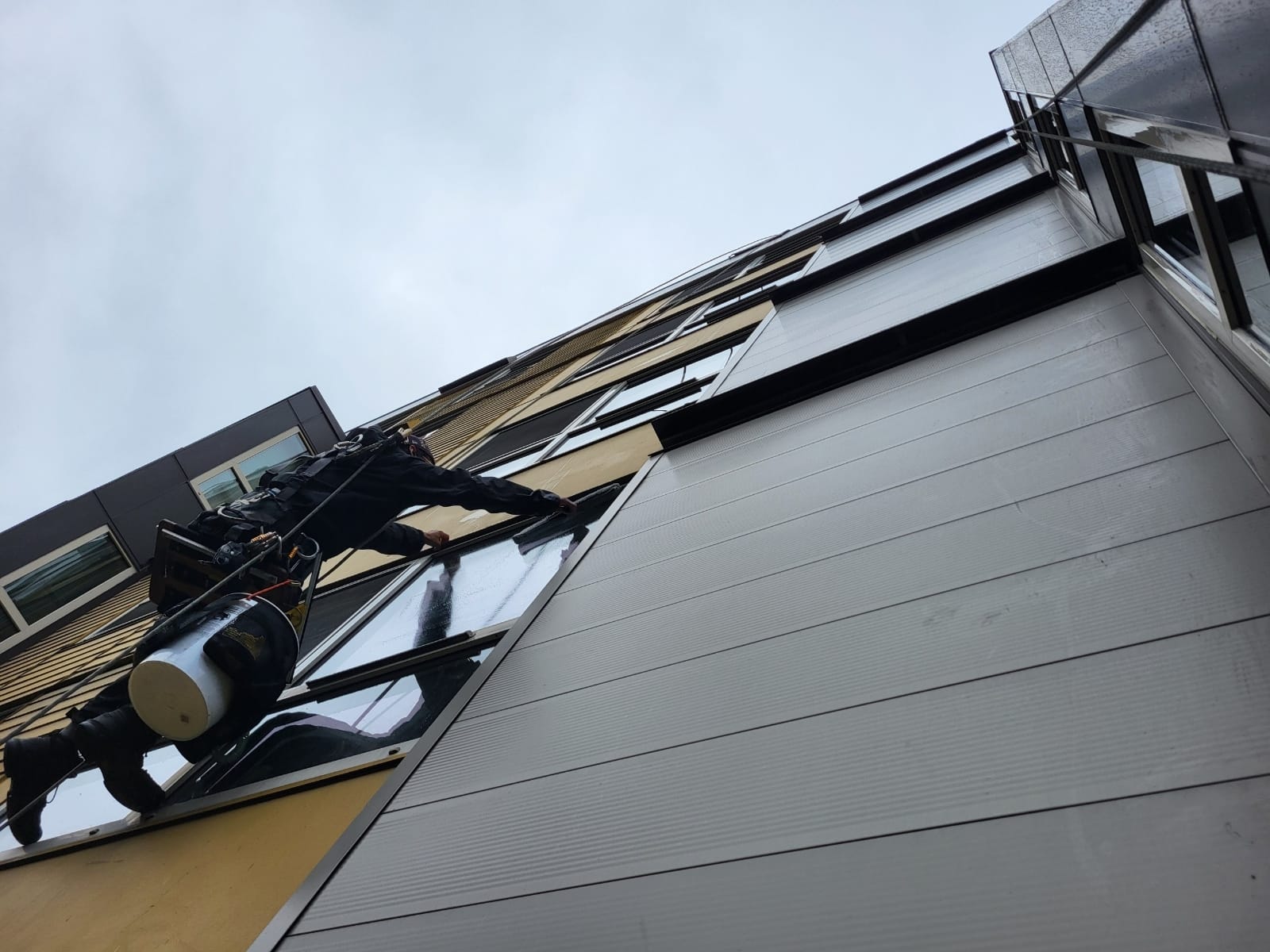 Rope access window cleaning technician