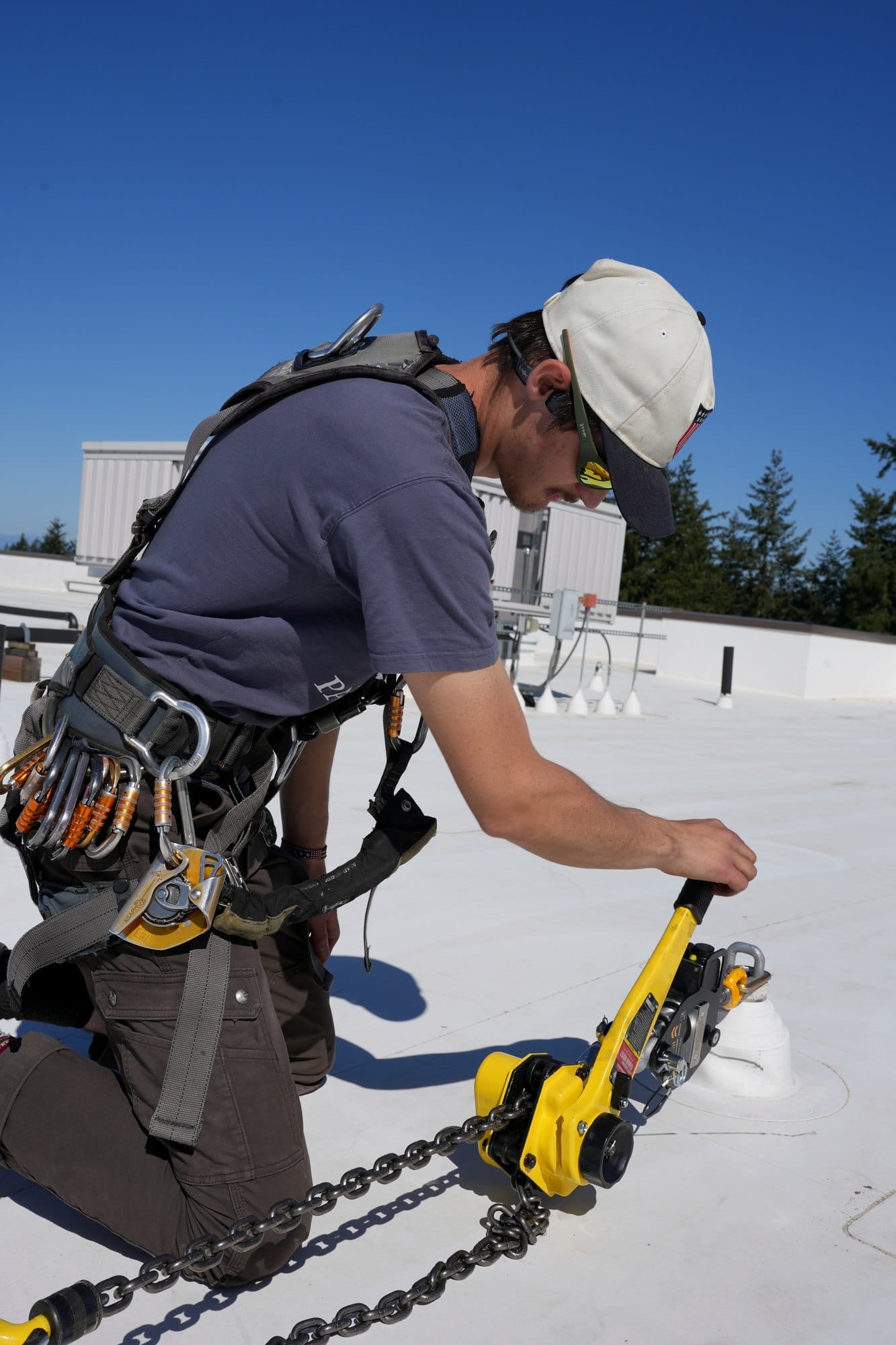 ADS technician performing rooftop anchor inspection